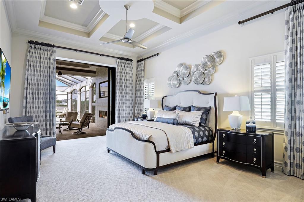 16459 Seneca Way Naples, FL 34110 - Photo 7 of 50 a spacious bedroom with a bed couch and a large window