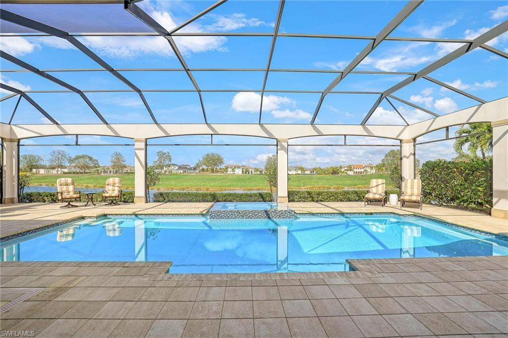 16459 Seneca Way Naples, FL 34110 - Photo 9 of 50 a view of a swimming pool with a porch