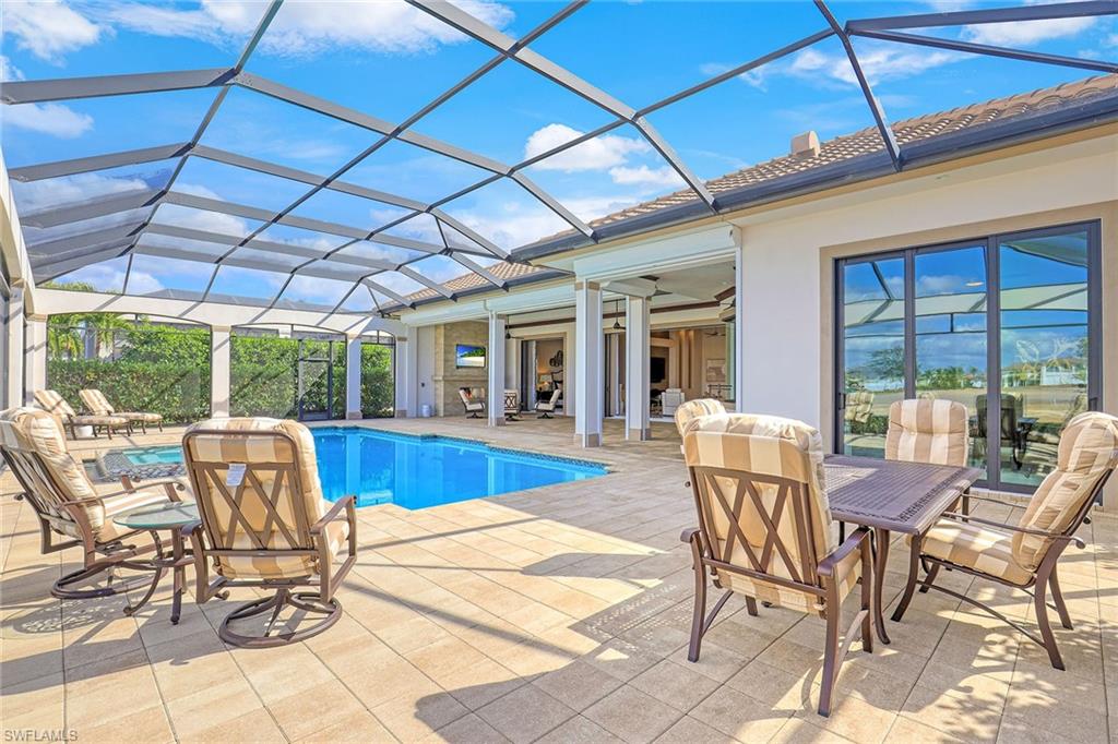 16459 Seneca Way Naples, FL 34110 - Photo 10 of 50 a view of a patio with dining table and chairs