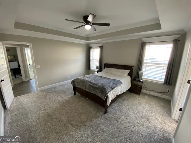 a bedroom with a bed and a ceiling fan