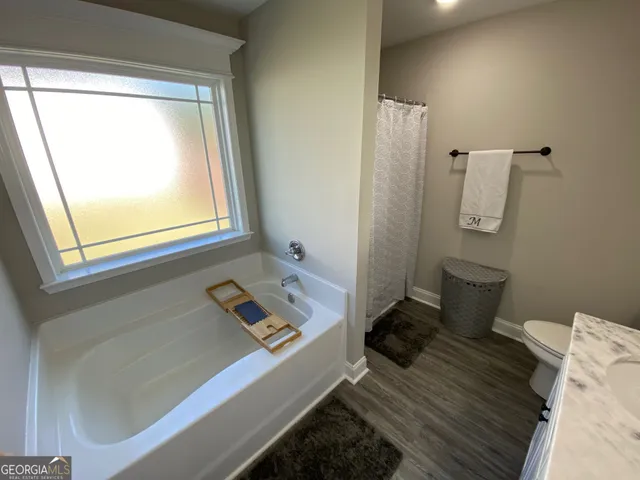 a living room with a bed and a window