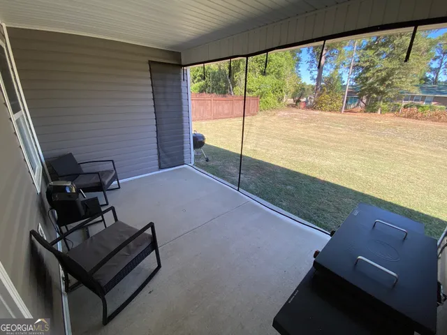 a view of a floor to ceiling window with an ocean view