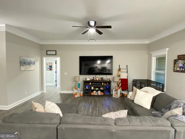 a living room with furniture and a flat screen tv