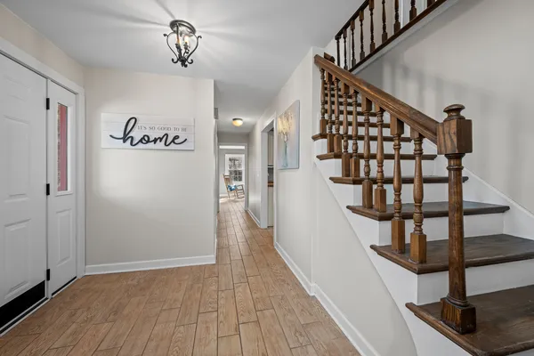 a view of entryway and hall with wooden floor