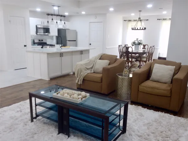 a living room with furniture and kitchen view