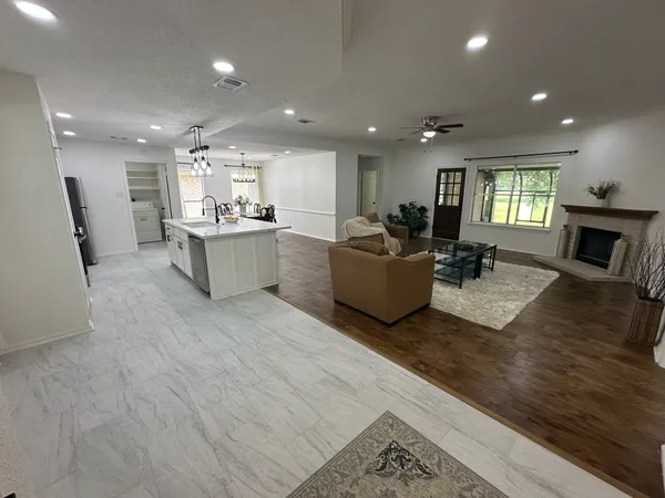 a living room with fireplace furniture and a wooden floor
