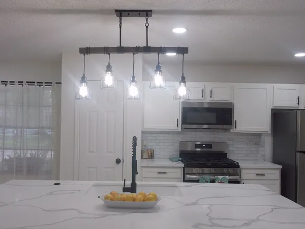 a kitchen with a refrigerator and a sink