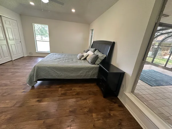 a bedroom with a bed and wooden floor