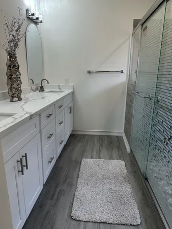 a bathroom with a double vanity sink and mirror