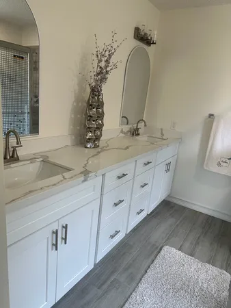a bathroom with a double vanity sink and a mirror