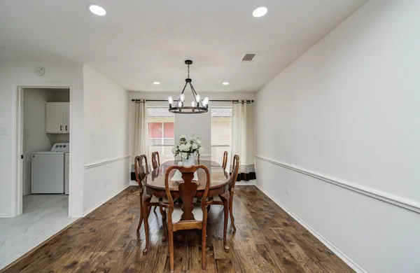 a view of a dining room with furniture and wooden floor
