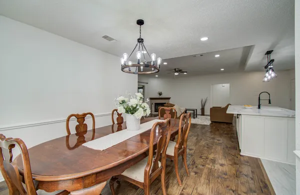 a view of a dining room with furniture and chandelier