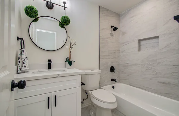 a bathroom with a sink a toilet and a mirror