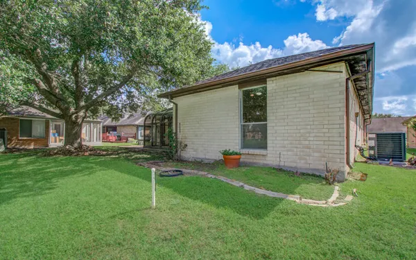 a backyard of a house with table and chairs