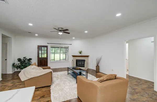 a living room with furniture fireplace and window