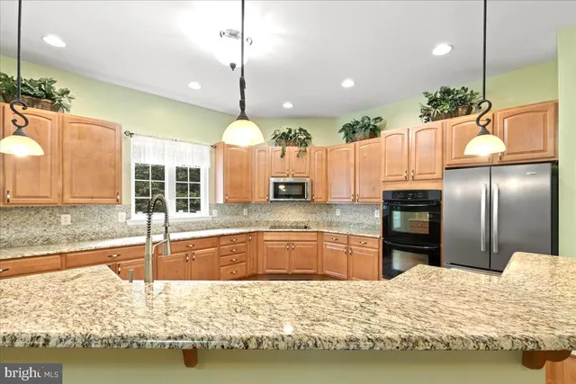 a kitchen with stainless steel appliances granite countertop a granite counter tops and a stove