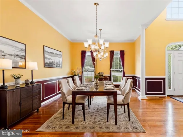 a living room with furniture fireplace and a large window