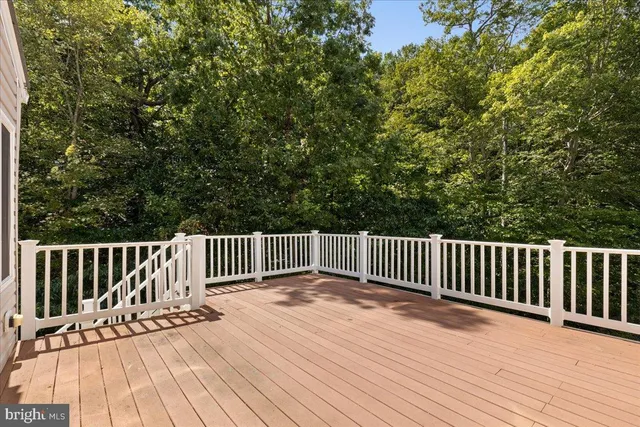 a front view of a house with a yard and potted plants