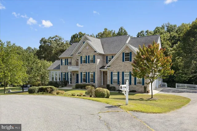 a front view of a house with swimming pool and porch