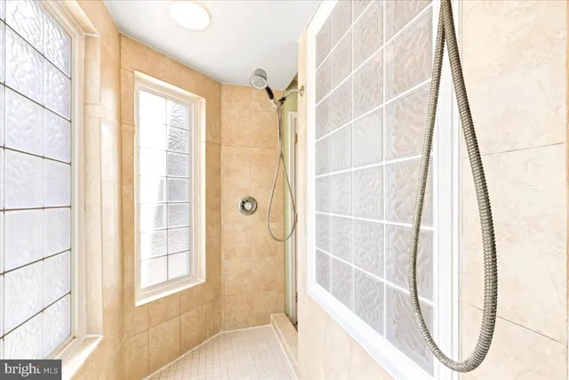 a spacious bathroom with a tub sink and mirror