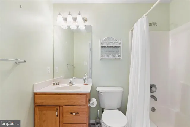 a living room with furniture a flat screen tv and a window