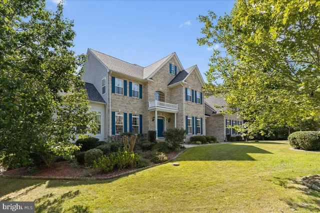 a house view with swimming pool and garden space