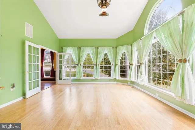an empty room with a ceiling fan and carpet