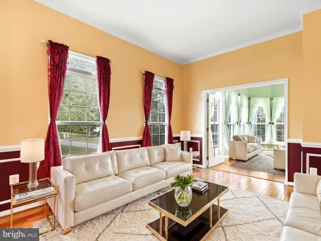 a living room with furniture fireplace and a large window
