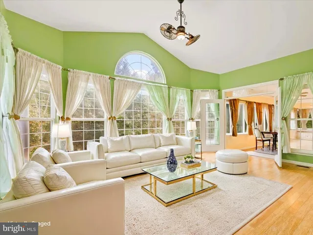 a large kitchen with cabinets wooden floor and stainless steel appliances