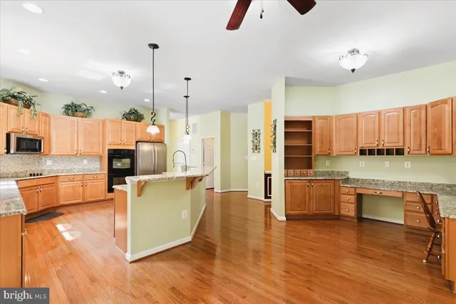 a kitchen with granite countertop a refrigerator oven a sink and dishwasher