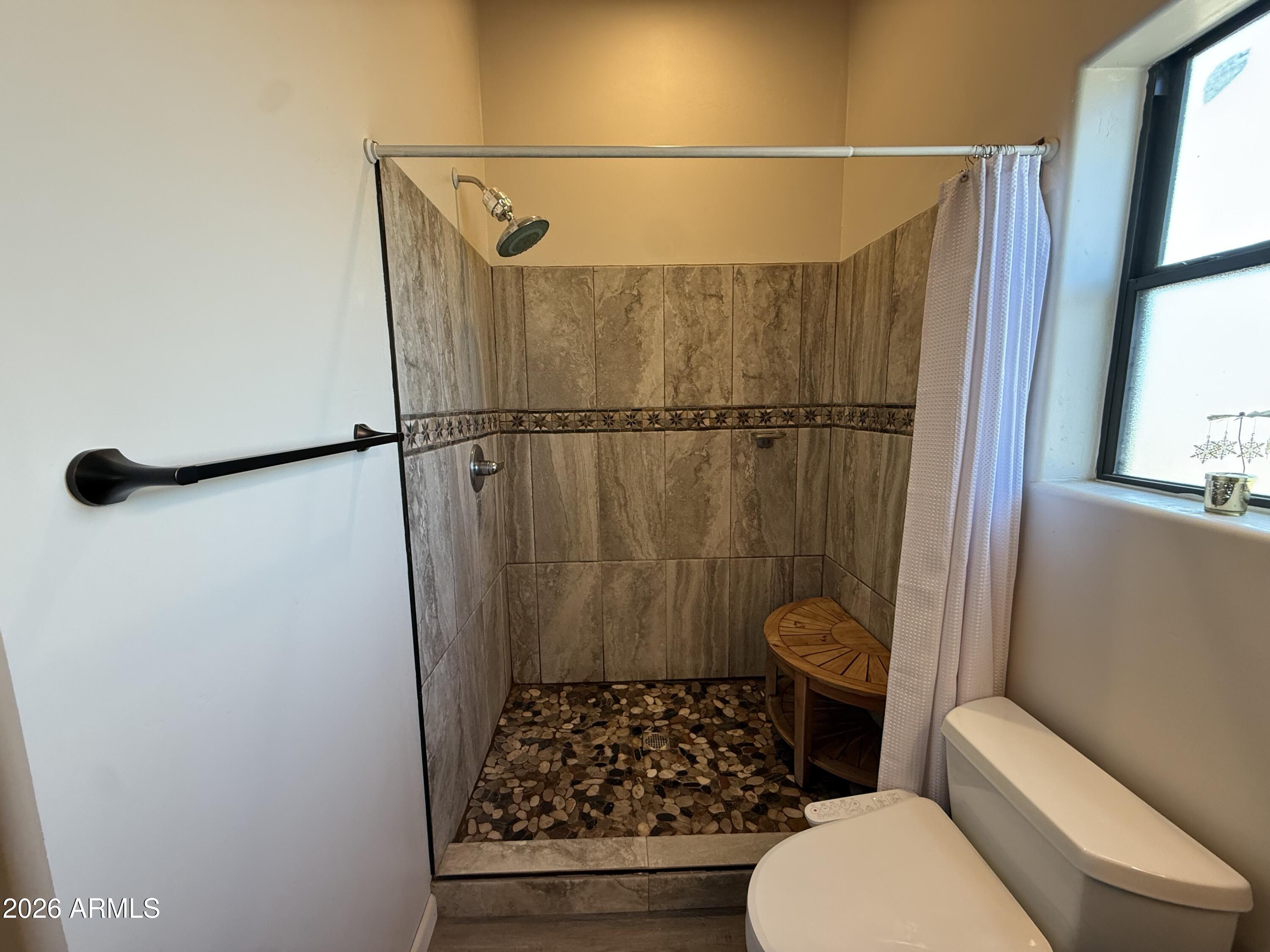 10545 North Ralston Road Maricopa, AZ 85139 - Photo 11 of 27 a bathroom with a toilet and a shower