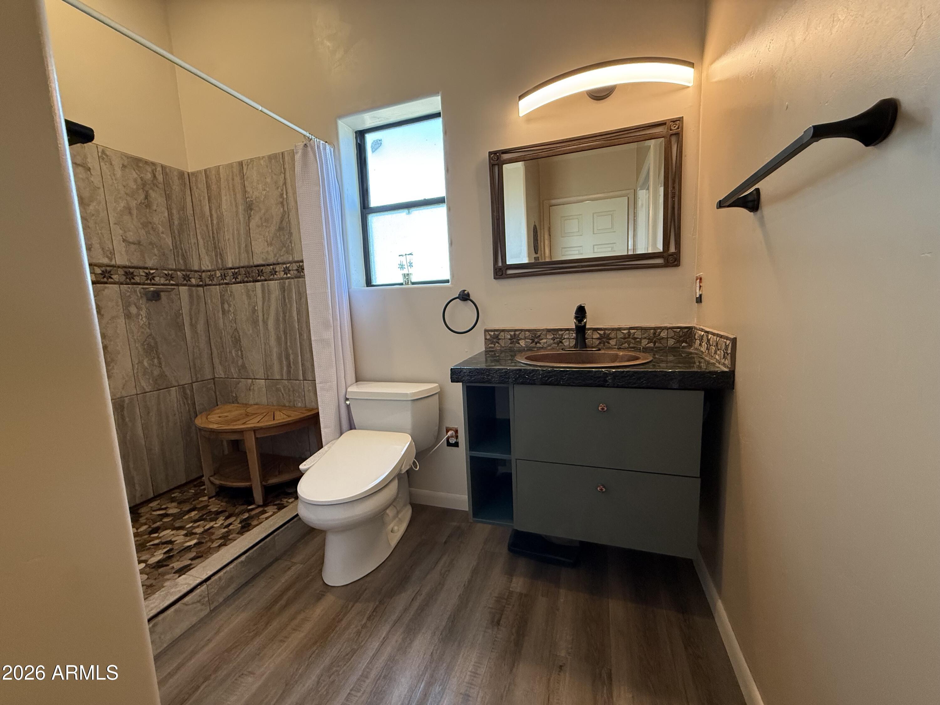 10545 North Ralston Road Maricopa, AZ 85139 - Photo 12 of 27 a bathroom with a toilet sink and mirror