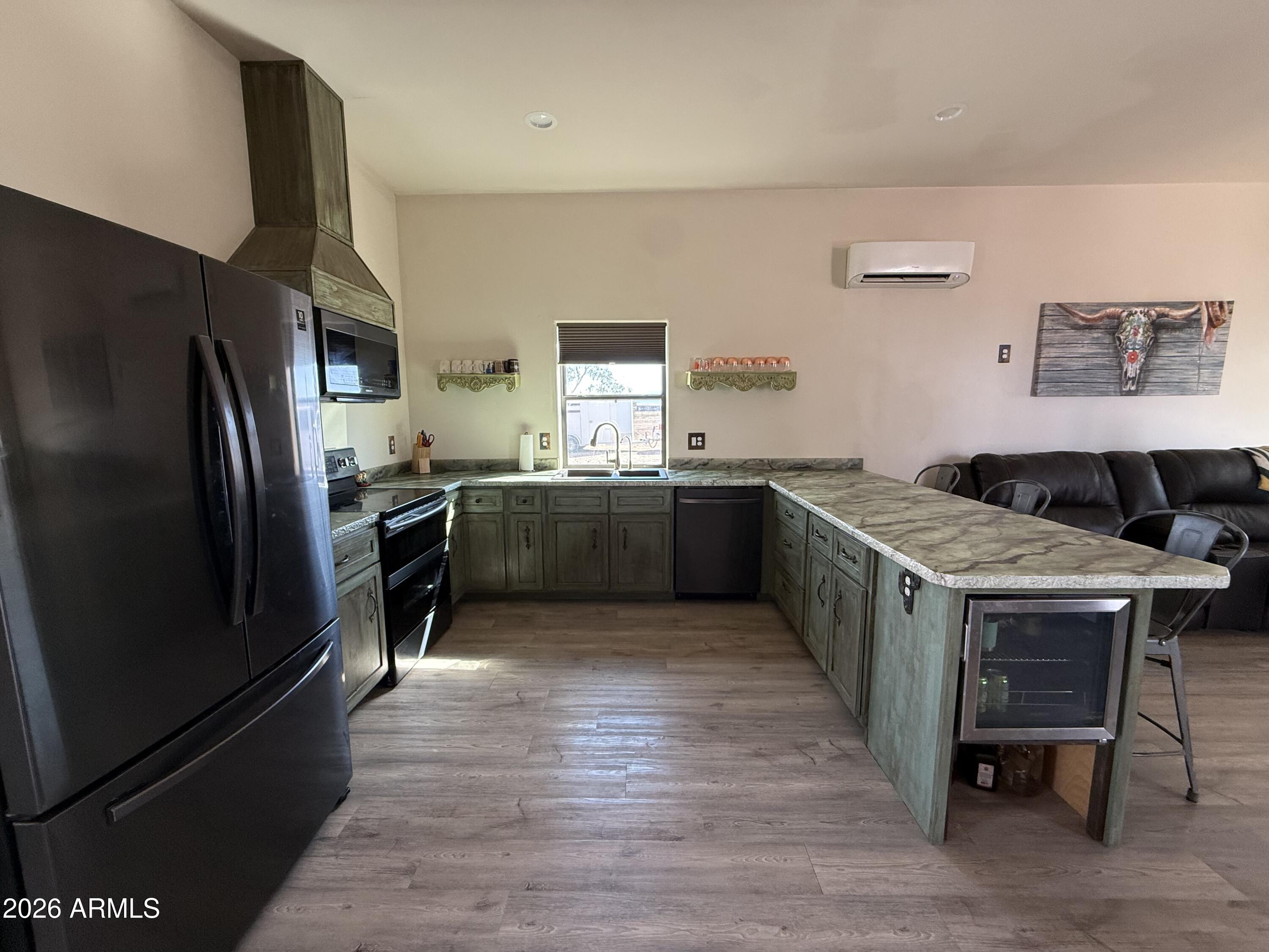10545 North Ralston Road Maricopa, AZ 85139 - Photo 4 of 27 a kitchen with stainless steel appliances granite countertop a stove a sink dishwasher a refrigerator and a oven