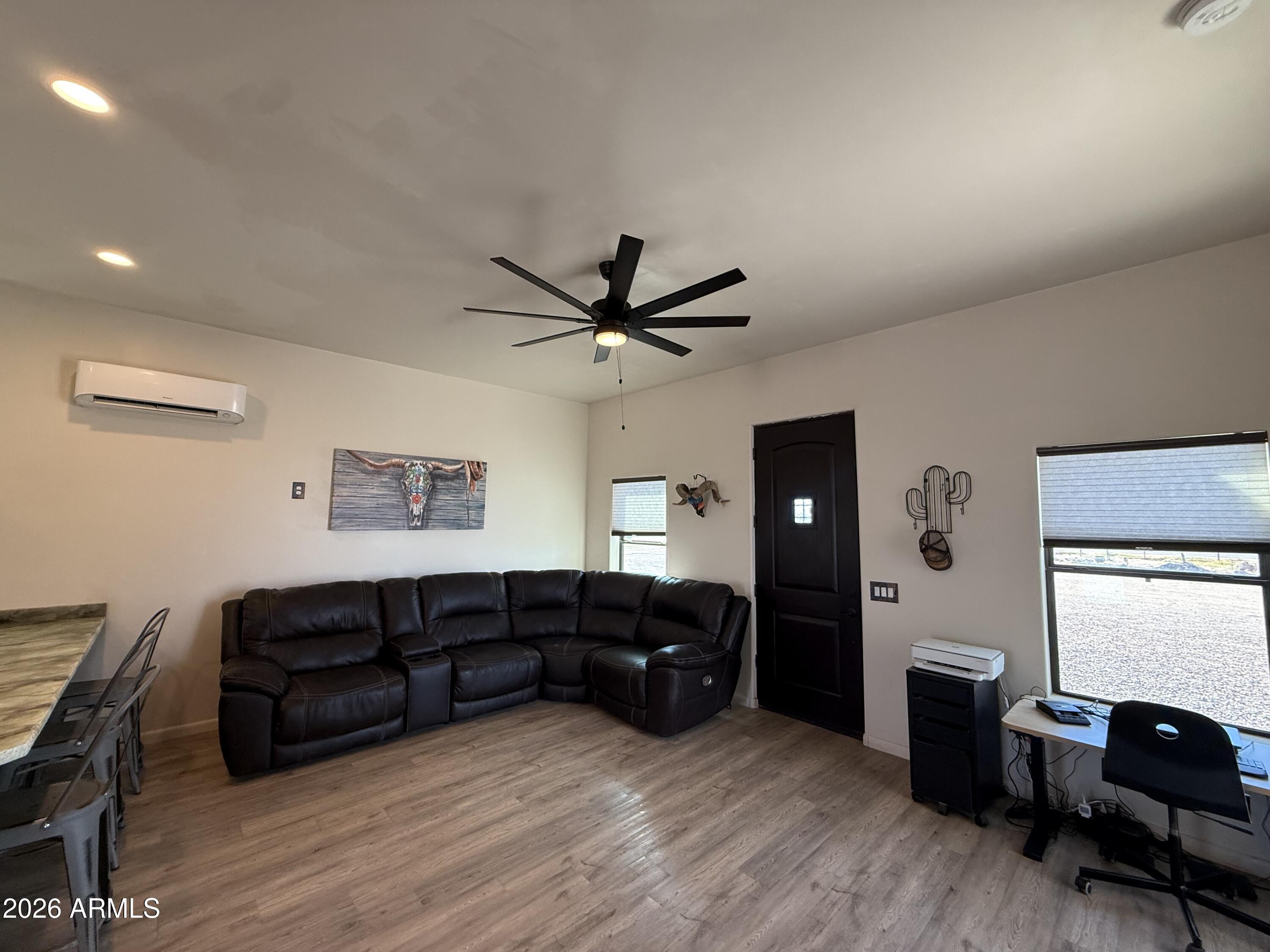 10545 North Ralston Road Maricopa, AZ 85139 - Photo 5 of 27 a living room with furniture and wooden floor