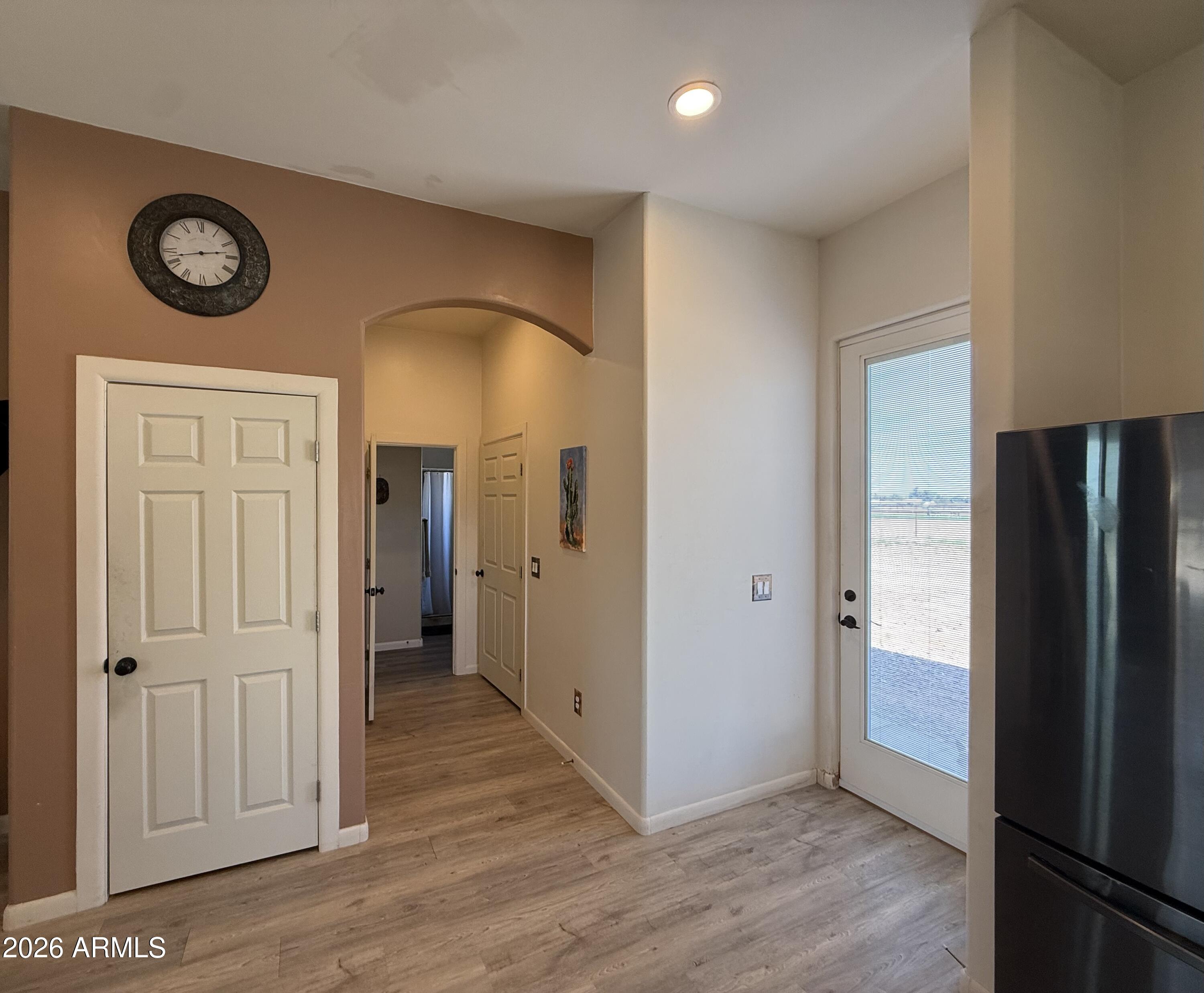 10545 North Ralston Road Maricopa, AZ 85139 - Photo 7 of 27 a view of a hallway with wooden floor