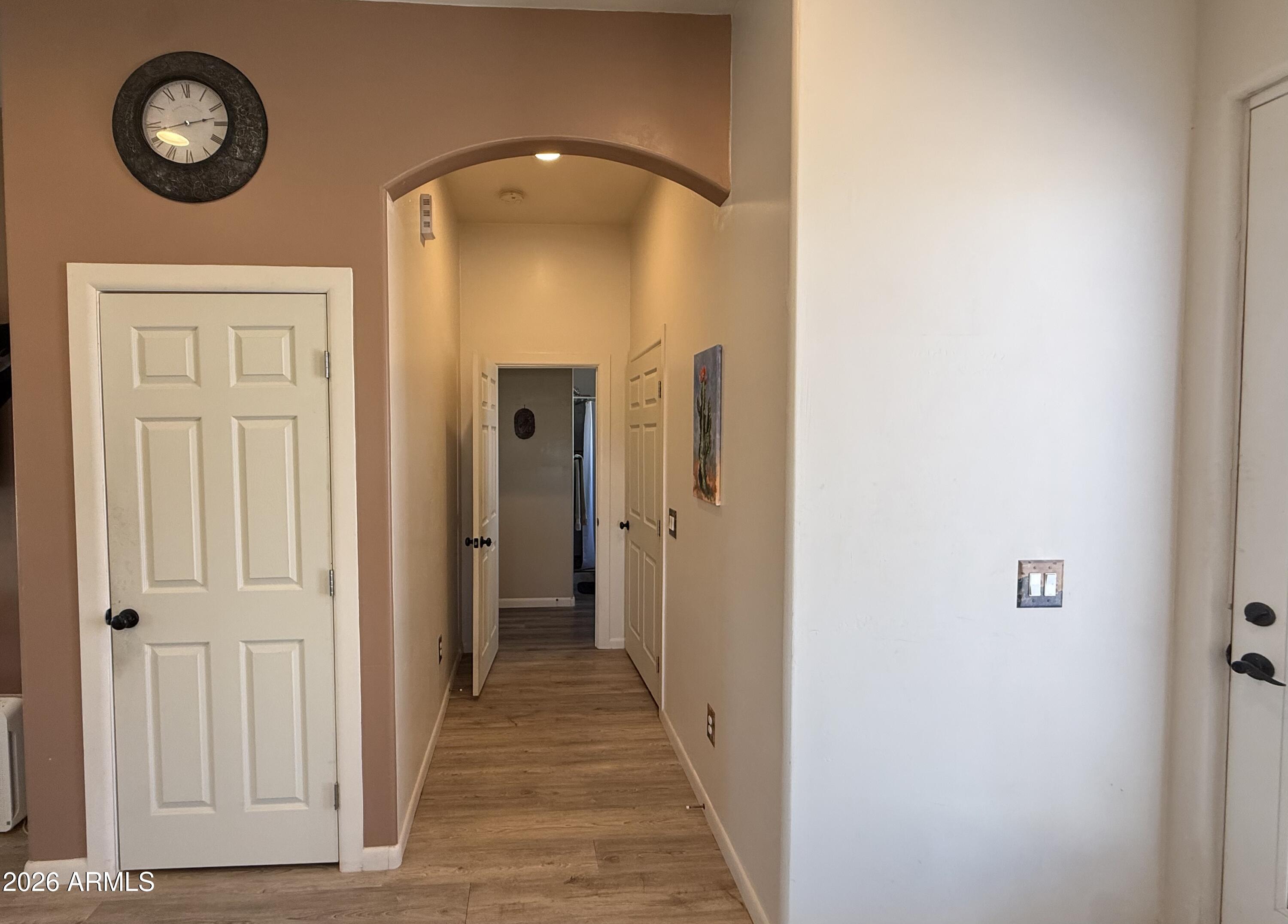 10545 North Ralston Road Maricopa, AZ 85139 - Photo 8 of 27 a view of a hallway with wooden floor