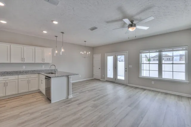 an open kitchen with a sink and dish washer