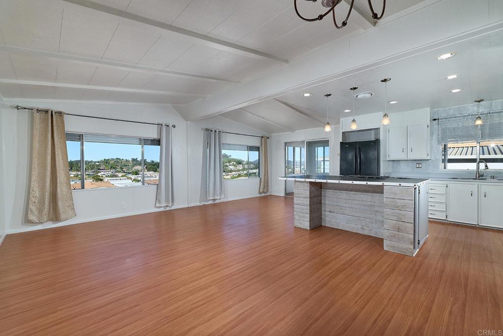 1195 La Moree Road, Unit SPC 42 San Marcos, CA 92078 - Photo 11 of 52 a view of an empty room and kitchen with wooden floor