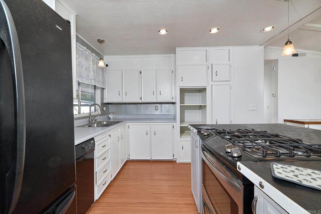 1195 La Moree Road, Unit SPC 42 San Marcos, CA 92078 - Photo 13 of 52 a kitchen with stainless steel appliances granite countertop a stove and a refrigerator