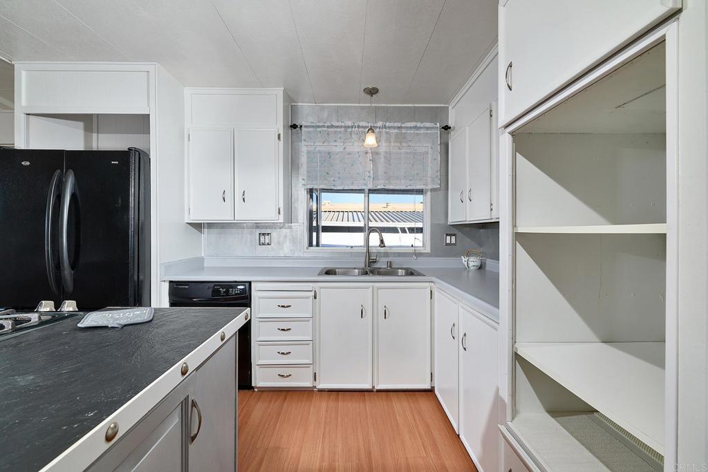 1195 La Moree Road, Unit SPC 42 San Marcos, CA 92078 - Photo 14 of 52 a kitchen with a sink stove and cabinets