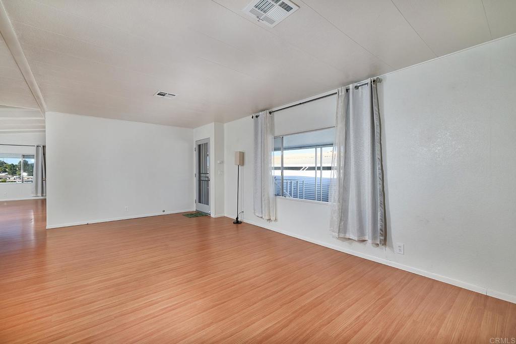 1195 La Moree Road, Unit SPC 42 San Marcos, CA 92078 - Photo 16 of 52 a view of an empty room with wooden floor and a window