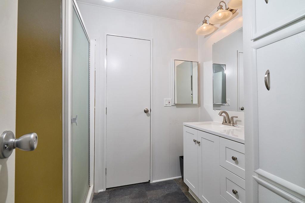1195 La Moree Road, Unit SPC 42 San Marcos, CA 92078 - Photo 25 of 52 a bathroom with a sink and mirror