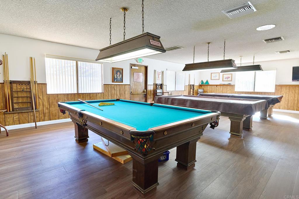 1195 La Moree Road, Unit SPC 42 San Marcos, CA 92078 - Photo 30 of 52 a room with wooden floors pool table and chairs