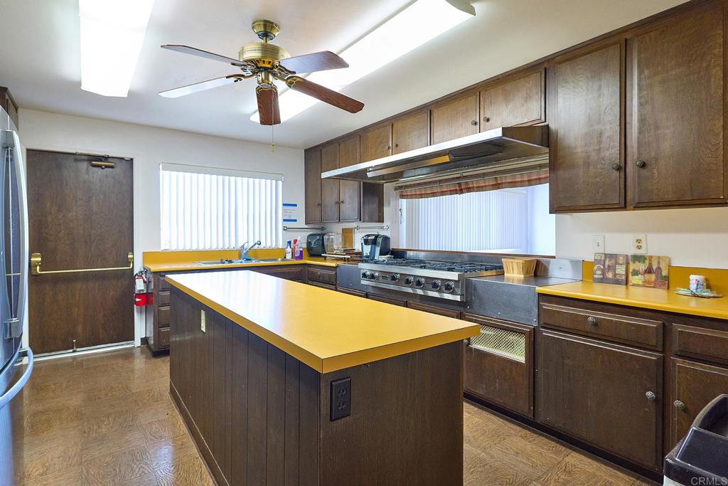 1195 La Moree Road, Unit SPC 42 San Marcos, CA 92078 - Photo 31 of 52 a kitchen with stainless steel appliances granite countertop a sink counter space cabinets and a refrigerator