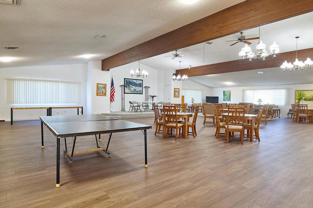 1195 La Moree Road, Unit SPC 42 San Marcos, CA 92078 - Photo 32 of 52 a living room with lots of furniture and a wooden floor