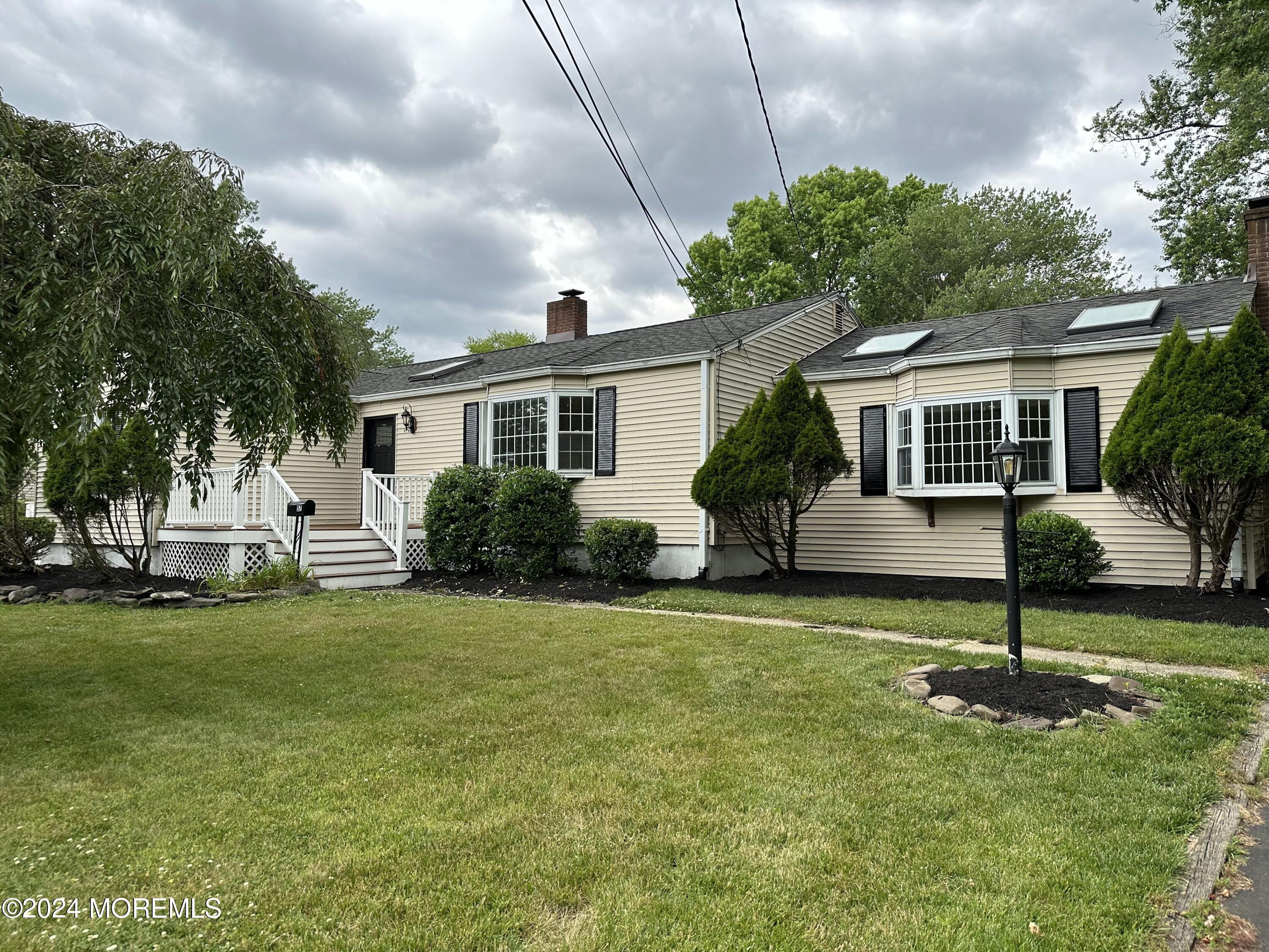 57 Kings Road Little Silver, NJ 07739 - Photo 1 of 22 a front view of a house with a garden