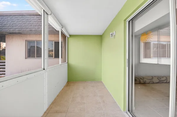 a view of hallway with a large window and chandelier