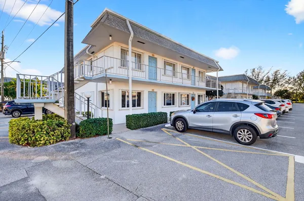 a front view of a residential apartment building with a yard