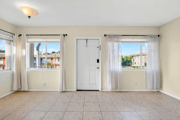 an empty room with closet and windows