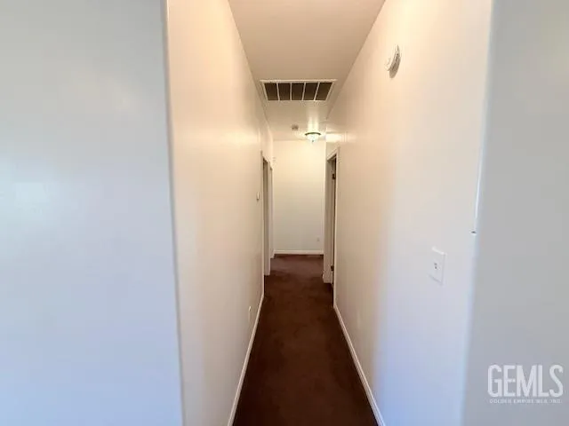 a view of a hallway with a door